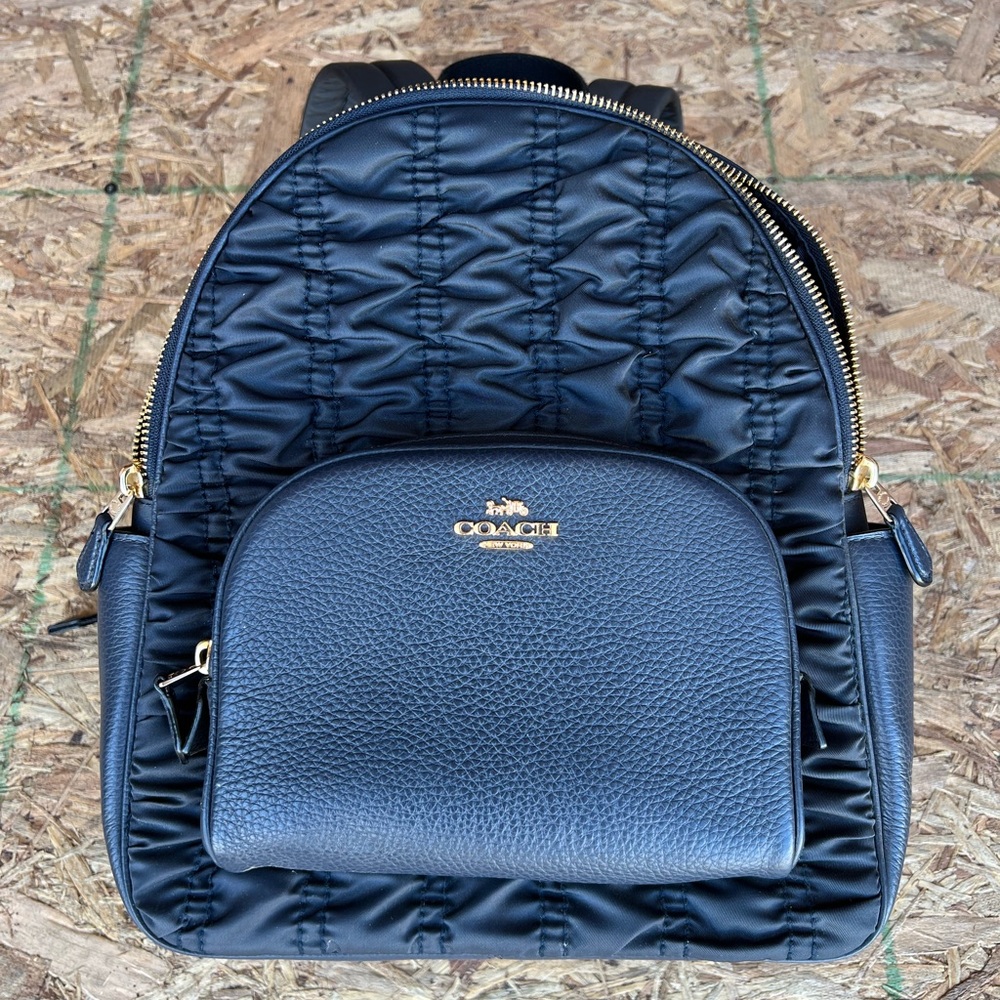 Small black coach backpack.